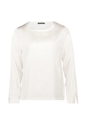 Long-sleeve blouse in smooth white satin, featuring a round neckline and side slits on the sleeves for ease of movement.