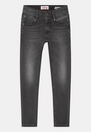 Jean slim noir avec détails délavés, cinq poches, passants de ceinture et fermeture par boutons, posé à plat sur un fond blanc.