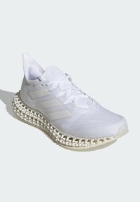 White athletic shoe featuring a mesh upper, three-striped design, and a unique textured sole with a lace-up closure and padded collar.