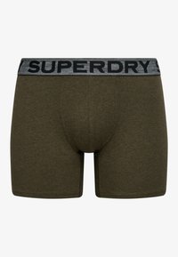 Boxers verts olive pour hommes avec une ceinture élastique grise avec un texte noir "SUPERDRY".