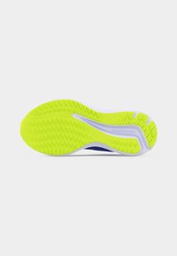 Bright yellow and white running shoe sole with textured grip and "Mizuno Enerzy" branding on a plain light background.