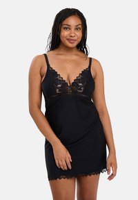 Black nightdress with lace trim, featuring a deep V-neck and adjustable straps. Made from soft fabric, it has a sleek, fitted silhouette.
