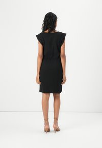 Black dress with short, ruffled sleeves, fitted waist, and a straight silhouette. Made of soft fabric with a smooth texture.