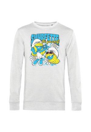 Felpa bianca con due personaggi di Puffetta, uno che tiene un telefono, testo "SMURFETTE Be yourself" e fiori bianchi sullo sfondo.