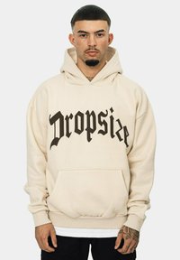 Beige hoodie made of cotton blend, featuring a large black gothic font print reading "Dropsize." Includes a front pocket and drawstring hood.