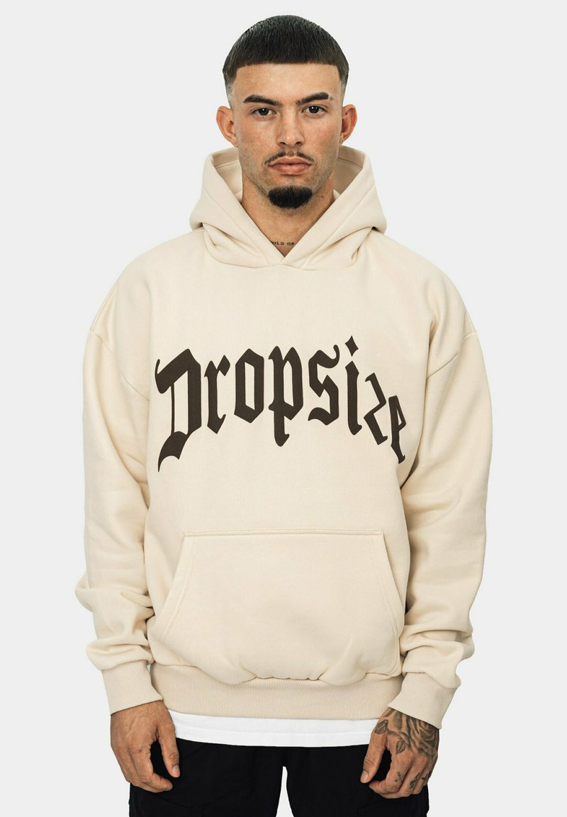 Beige hoodie made of cotton blend, featuring a large black gothic font print reading "Dropsize." Includes a front pocket and drawstring hood.