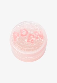 Maschera in gel trasparente in un contenitore circolare rosa, etichettato "Abib," con le lettere rosa "PDRN" che fluttuano all'interno. Texture liscia, superficie riflettente.