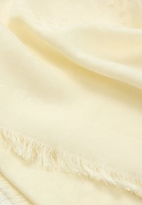 Light yellow scarf made of soft fabric, featuring a subtle texture and fringed edges for added detail.