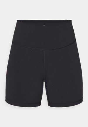 Shorts de sport noirs en tissu extensible. Dotés d'une taille haute et de coutures lisses. Adaptés pour le sport et l'exercice.