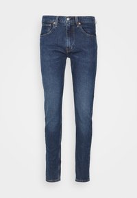 Mörkblå denimjeans med rak passform, fem fickor, metallknapp och dragkedjestängning, samt diskret blekning på tyget.