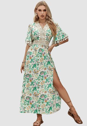 Vestido maxi floral con base blanca, que presenta patrones en verde, rosa y amarillo. Mangas cortas, escote en V y detalles de encaje con una abertura lateral.