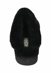 Black slipper with a fuzzy interior, open back design, flat sole, and fabric label on the insole. Soft texture throughout.