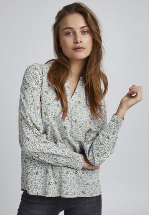 Langärmlige Bluse mit Blumenmuster auf hellem Hintergrund, bunten Blumenprints, V-Ausschnitt und elastischen Bündchen.