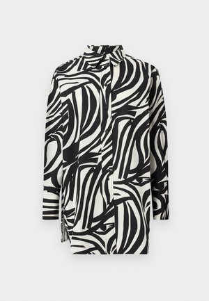 Button-up shirt with long sleeves in black and white. Features a wavy striped pattern, collar, and side slits for a relaxed fit.