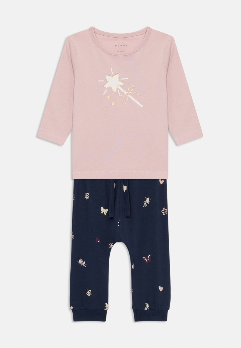Pink long-sleeve top with a glittery star graphic, paired with navy pants featuring colorful floral and butterfly patterns. Elastic waistband.