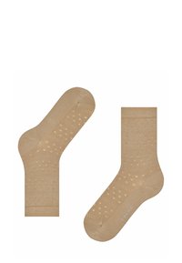 Beżowe skarpetki w kropki, wykonane z miękkiego materiału. Wyposażone w ściągacze i gładką fakturę. Logo widoczne na boku.
