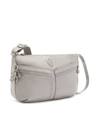 Light gray nylon crossbody bag with two zipped pockets, textured fabric, adjustable strap, and a charm accent attached to the zipper.