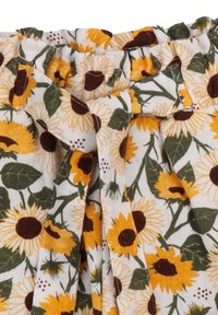 White fabric adorned with a sunflower pattern, featuring yellow petals, brown centers, and green leaves, gathered at the waist with a bow detail.