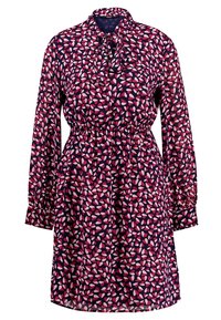 Marineblå klänning med långa ärmar, prydd med ett rosa och vitt lövmönster. Inkluderar en slips vid halsen och ett elastiskt midjeband för form.