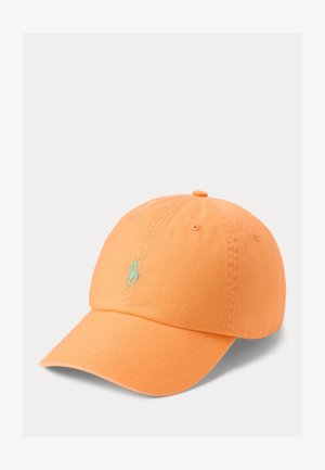 Oranžs kokvilnas beisbola cepure ar noapaļotu kroni, izliekto vizieri un mazu zaļu izšūtu logotipu priekšpusē. Tekstūrēta auduma.