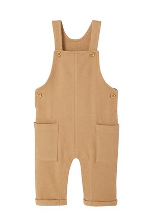 Beige gestrickter Overall für Kleinkinder mit geknöpften Trägern, seitlichen Knöpfen, großen aufgesetzten Fronttaschen und umgeschlagenen Bündchen.