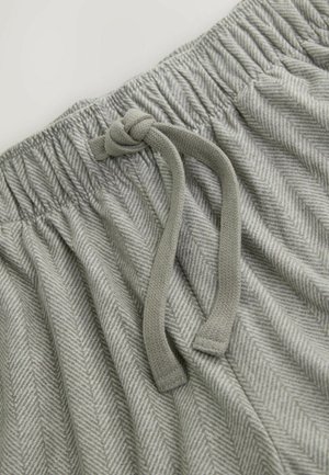 Grau gemusterter Stoff mit einem Fischgrätenmuster und einer strukturierten Oberfläche. Ein elastischer Bund mit einem geknoteten Kordelzug zur Anpassung.