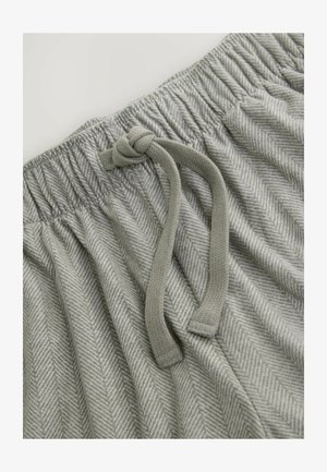 Szaro-wzorzysty materiał ma wzór w jodełkę z fakturowanym wykończeniem. Elastyczny pasek w talii zawiera związany sznurek do regulacji.