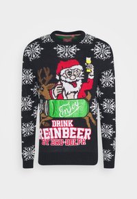 Pull noir avec un thème de Noël comprenant un Père Noël, un renne et des flocons de neige. Des textes et motifs en rouge vif, vert et blanc sont bien visibles.