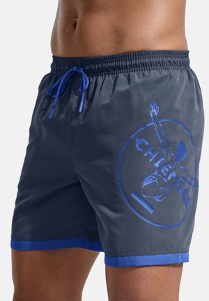 Herren-Badeshorts aus dunkelgrauem Stoff mit blauen Akzenten. Ausgestattet mit einem elastischen Bund mit Kordelzug und einem großen blauen Logo an der Seite.