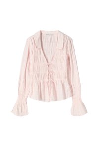 Pink, long-sleeve blouse with a collared neckline, smocked details, and flared cuffs; features tie closures at the front. Soft, textured fabric.
