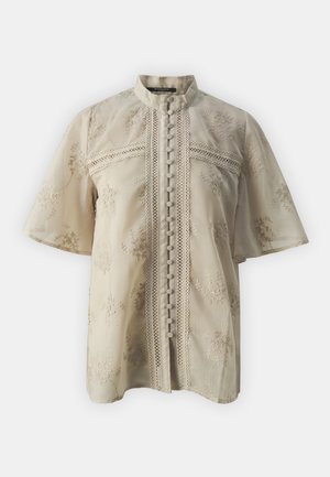 Beige Bluse mit kurzen Ärmeln, versehen mit floraler Stickerei, Stehkragen, Knopfleiste und Spitze entlang der Mitte und der Ärmel.