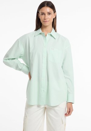 Light green striped button-up shirt with a collar, single chest pocket, and long sleeves; made from a smooth, lightweight fabric.