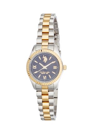 Montre-bracelet en métal bicolore argent et or avec cadran noir, chiffres romains dorés et logo U.S. Polo Assn. à 12 heures.