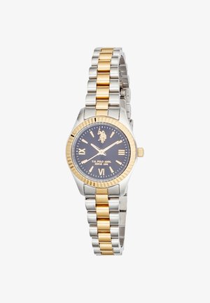 Montre-bracelet en métal bicolore argent et or avec cadran noir, chiffres romains dorés et logo U.S. Polo Assn. à 12 heures.
