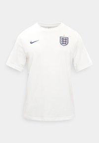 Λευκή ποδοσφαιρική φανέλα Αγγλίας με κοντό μανίκι, με ναυτικό μπλε λογότυπο Nike στο δεξί στήθος και έμβλημα Αγγλίας με χρυσό αστέρι στο αριστερό στήθος.