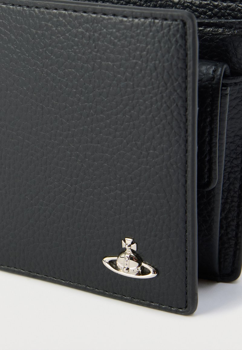 Sort tekstureret læderpung med et sølvemblem og kontrasterende syninger. Kompakt design med en glat finish og diskrete detaljer.