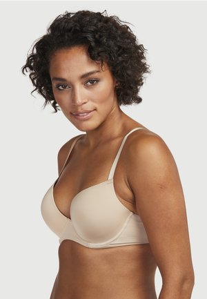 Nude balconette beha met gladde, lichtgevulde cups en verstelbare bandjes. Bevat een naadloos ontwerp en subtiele textuurstof.