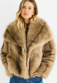 Brown faux fur coat with a large, soft collar and relaxed fit. Features front pockets and textured fabric, creating a plush appearance.