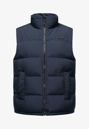 Tumesinine puhviste, millel on kõrge krae, täispikkari ja kaks küljetaskut. Omab tikkimistekstiili ja musta logo plaastrit.