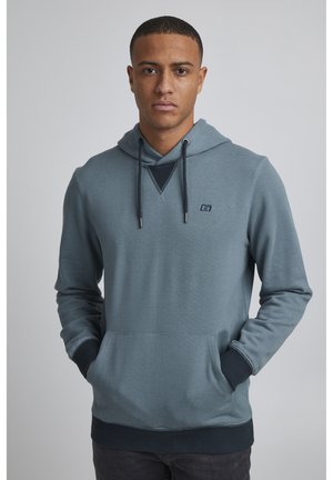 Hooded sweatshirt in blue gray fabric, featuring a front pocket, ribbed cuffs and hem, with a small logo on the chest and textured neckline.