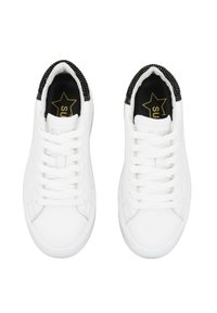 Zapatillas blancas con un exterior sintético suave, cordones planos y un cuello texturizado negro. Presentan un logo y acentos dorados en la plantilla.