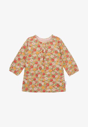 Floral long-sleeve top featuring a pastel pink background, colorful flower patterns in red, orange, and green, with a round neckline and button detail.