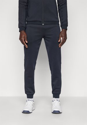 DOMINO - Calças de fato de treino - black