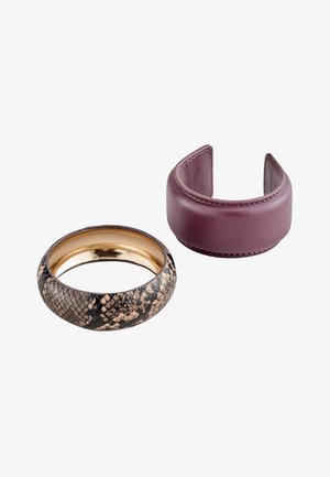 Two bracelets, one with purple leather cuff style and one with a snakeskin pattern and gold interior.