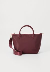 Burgundy tote bag in soft material with two top handles and an adjustable shoulder strap. Features gold-tone hardware and zip closure.