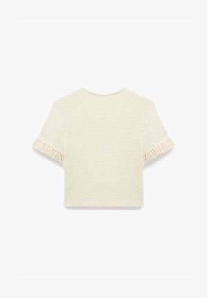 Lys creme kortærmet top i struktureret stof. Har flæse detaljer ved ærmerne og en klassisk rund halsudskæring.