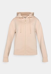 Φωτεινή μπεζ φούτερ με φερμουάρ, διαθέτει κουκούλα με κορδόνια, τσέπες μπροστά και ριμπ μανσέτες. Κατασκευασμένο από απαλό ύφασμα με λεία υφή.