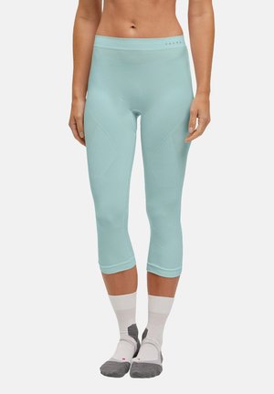 Lichtblauwe, driekwart lange leggings met een textuurontwerp, elastische tailleband en een gladde stof. Gedragen met witte en grijze sokken.