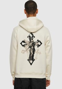 Hooded sweatshirt in off-white fabric featuring a large black and gray angel graphic on the back, with a cross and ornate design elements.