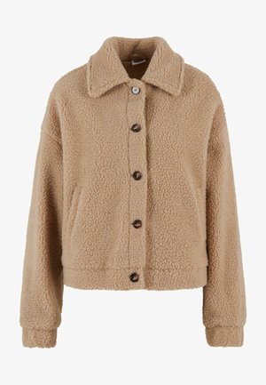 Chaqueta corta marrón y esponjosa con cierre de botones, dos bolsillos laterales y un collar. Tejido texturizado con un aspecto suave y cálido.